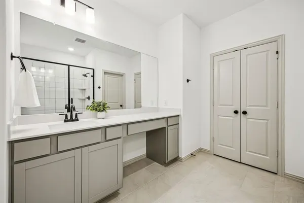 a bathroom with a double vanity sink and mirror