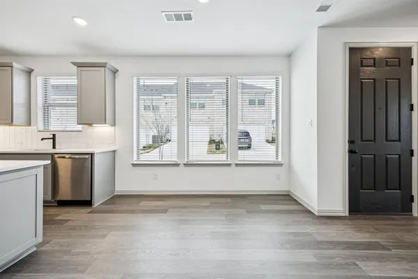 a view of kitchen with granite countertop window and front door
