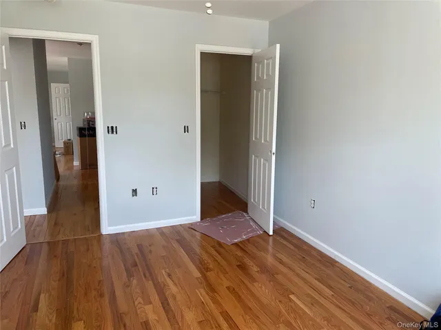a room with wooden floor and windows