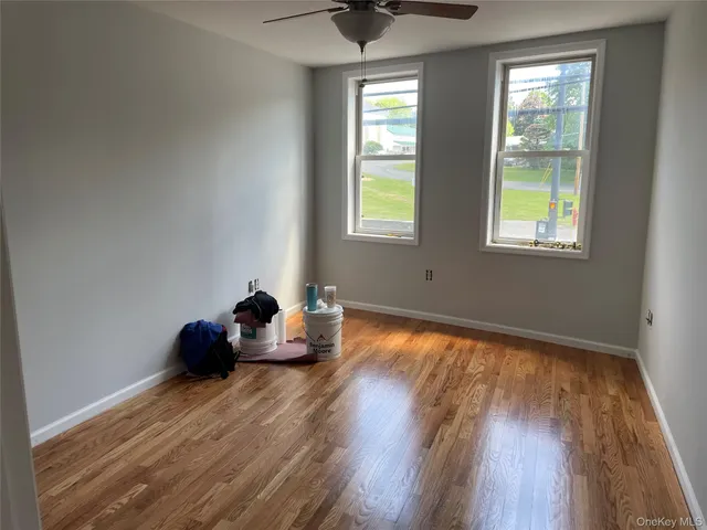 a living room with furniture and floor to ceiling windows