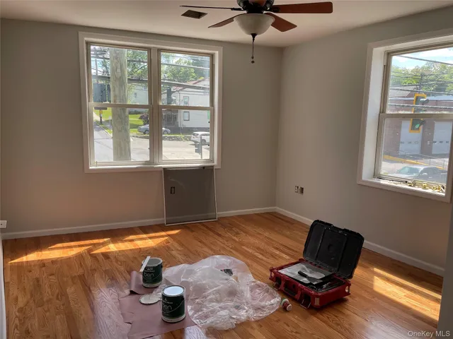 a view of an empty room and wooden floor