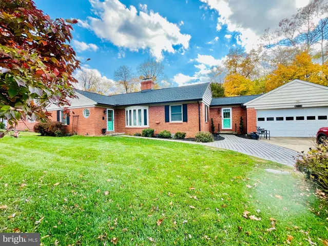 a front view of house with yard and green space