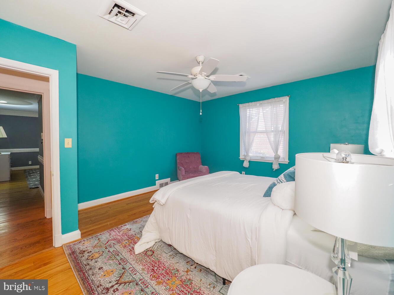 1108 Hampton Garth Towson, MD 21286 - Photo 18 of 53 a bedroom with a bed and a chandelier