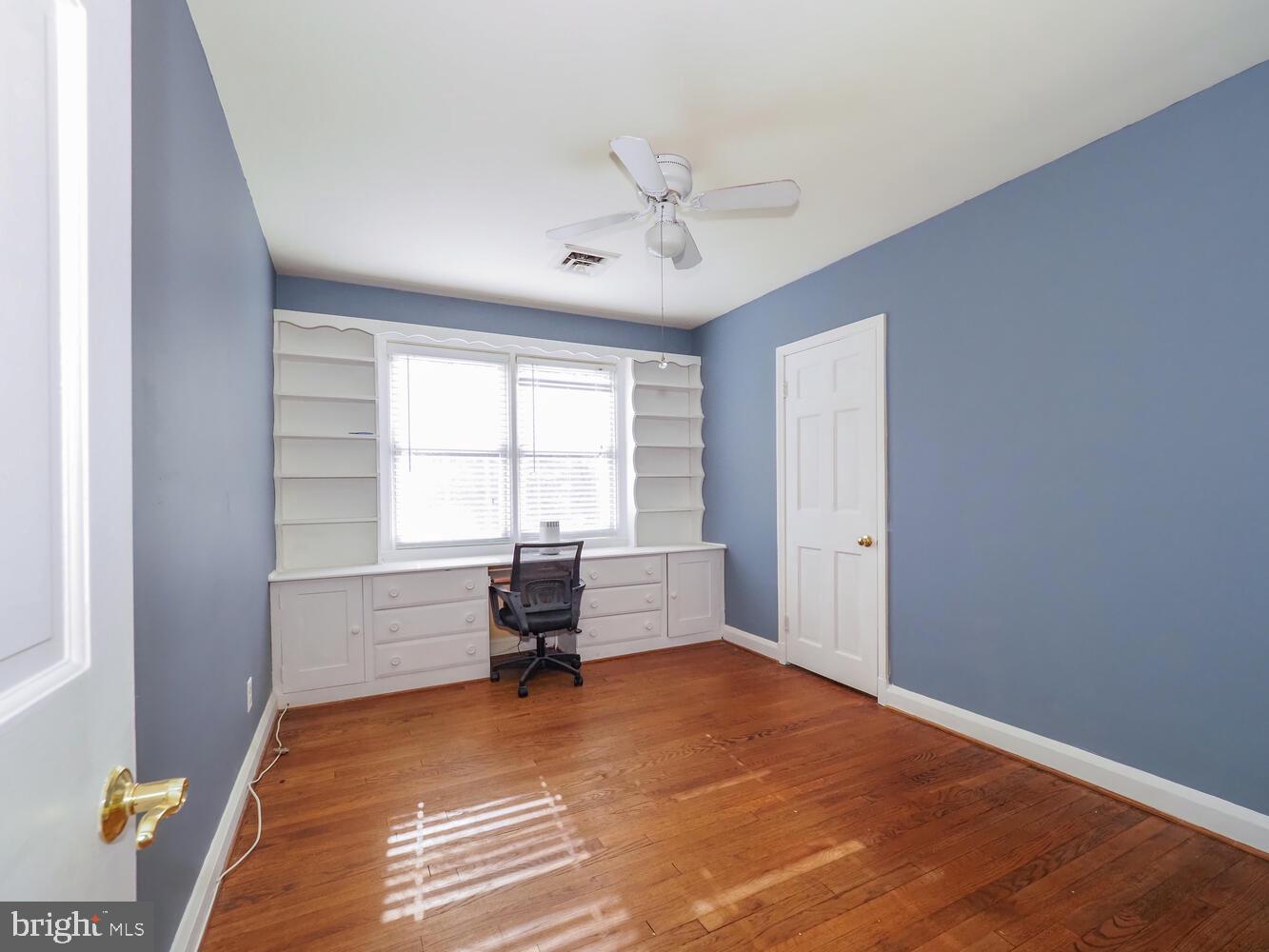 1108 Hampton Garth Towson, MD 21286 - Photo 22 of 53 a view of empty room with wooden floor and fan