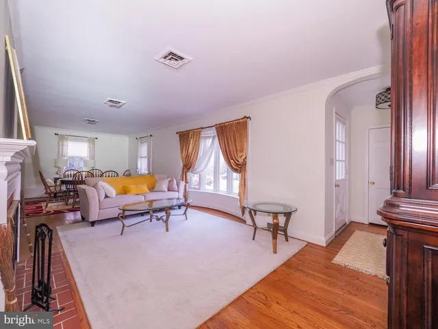 a living room with furniture a fireplace and a large window