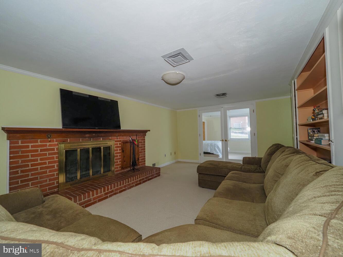 1108 Hampton Garth Towson, MD 21286 - Photo 45 of 53 a living room with furniture a fireplace and a flat screen tv