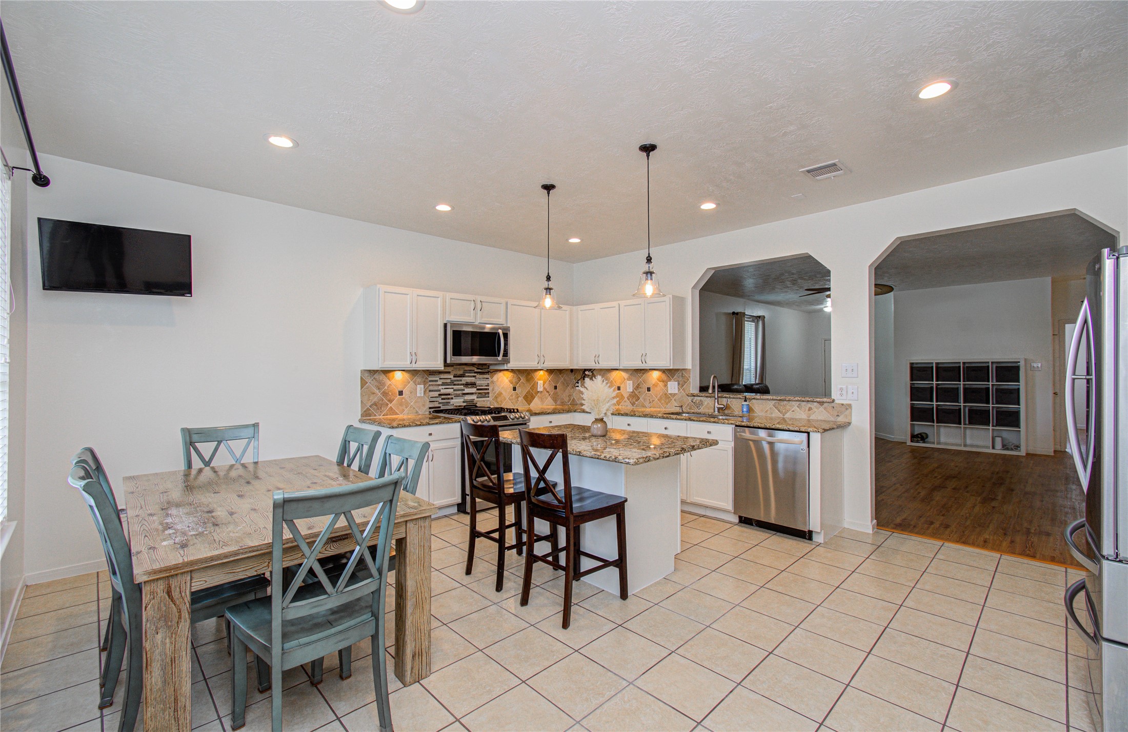 24135 Pinecreek Point Spring, TX 77373 - Photo 12 of 30 a large kitchen with a table and chairs in it