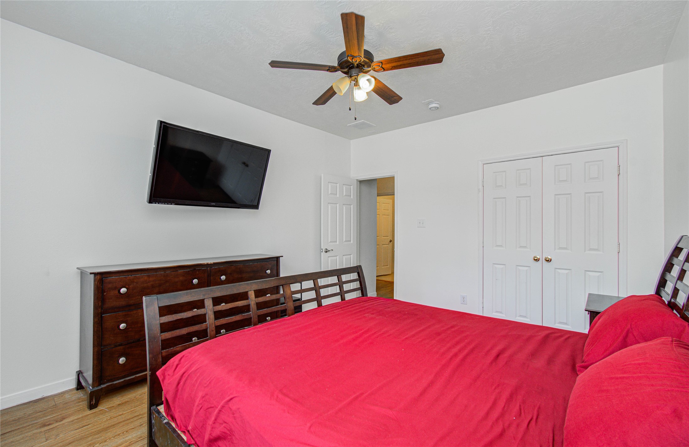 24135 Pinecreek Point Spring, TX 77373 - Photo 25 of 30 a bedroom with a bed and a flat screen tv