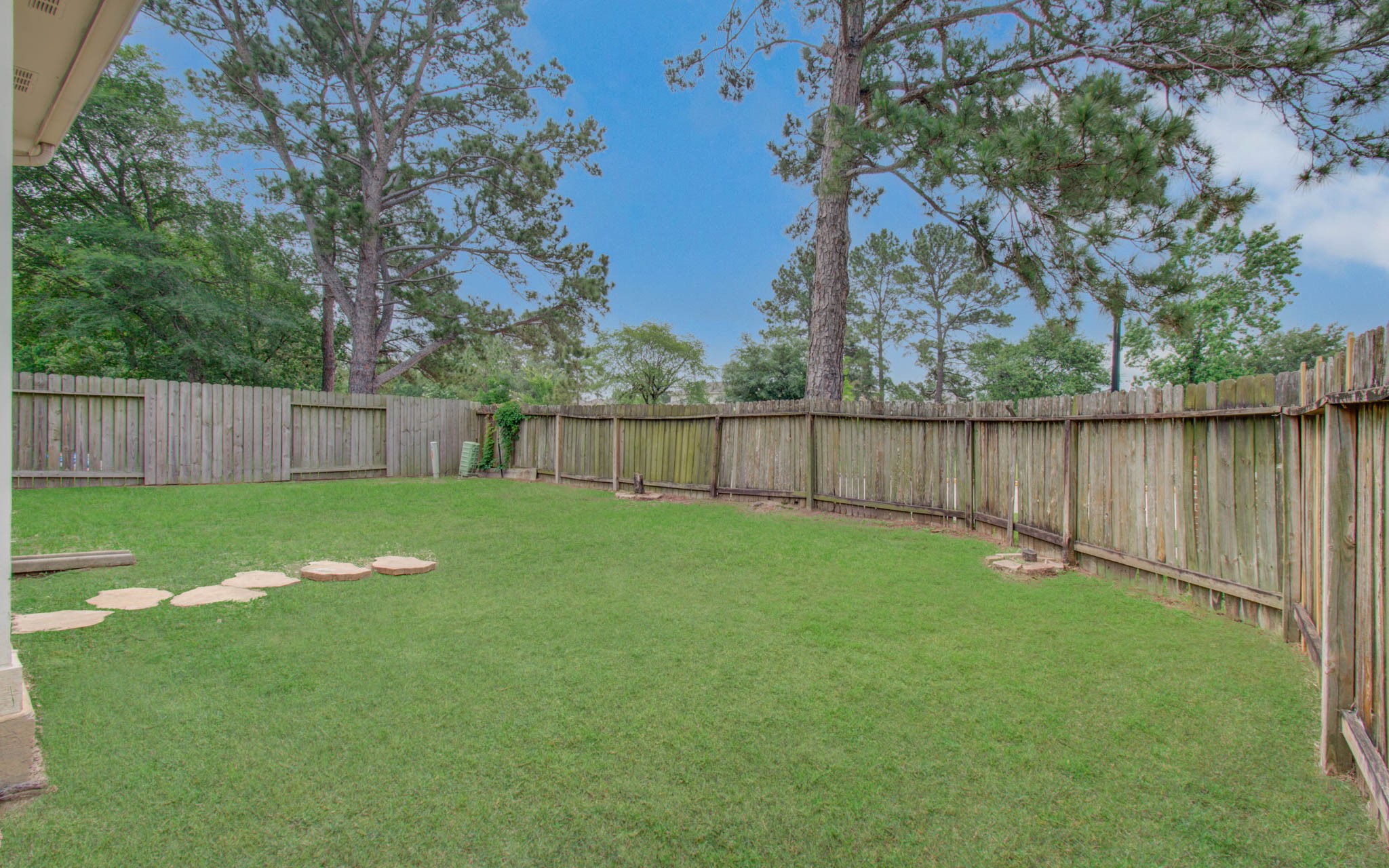 24135 Pinecreek Point Spring, TX 77373 - Photo 30 of 30 a view of a backyard with large trees and wooden fence