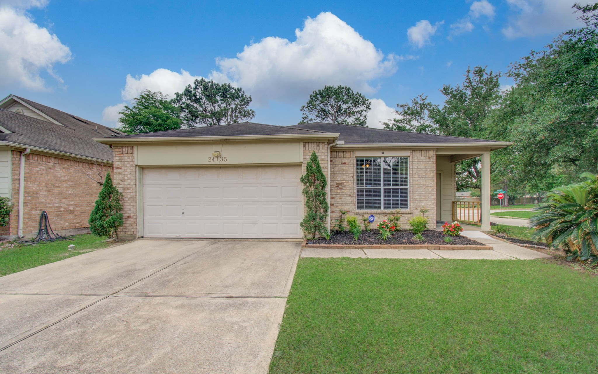 24135 Pinecreek Point Spring, TX 77373 - Photo 4 of 30 a front view of a house with a yard and garage