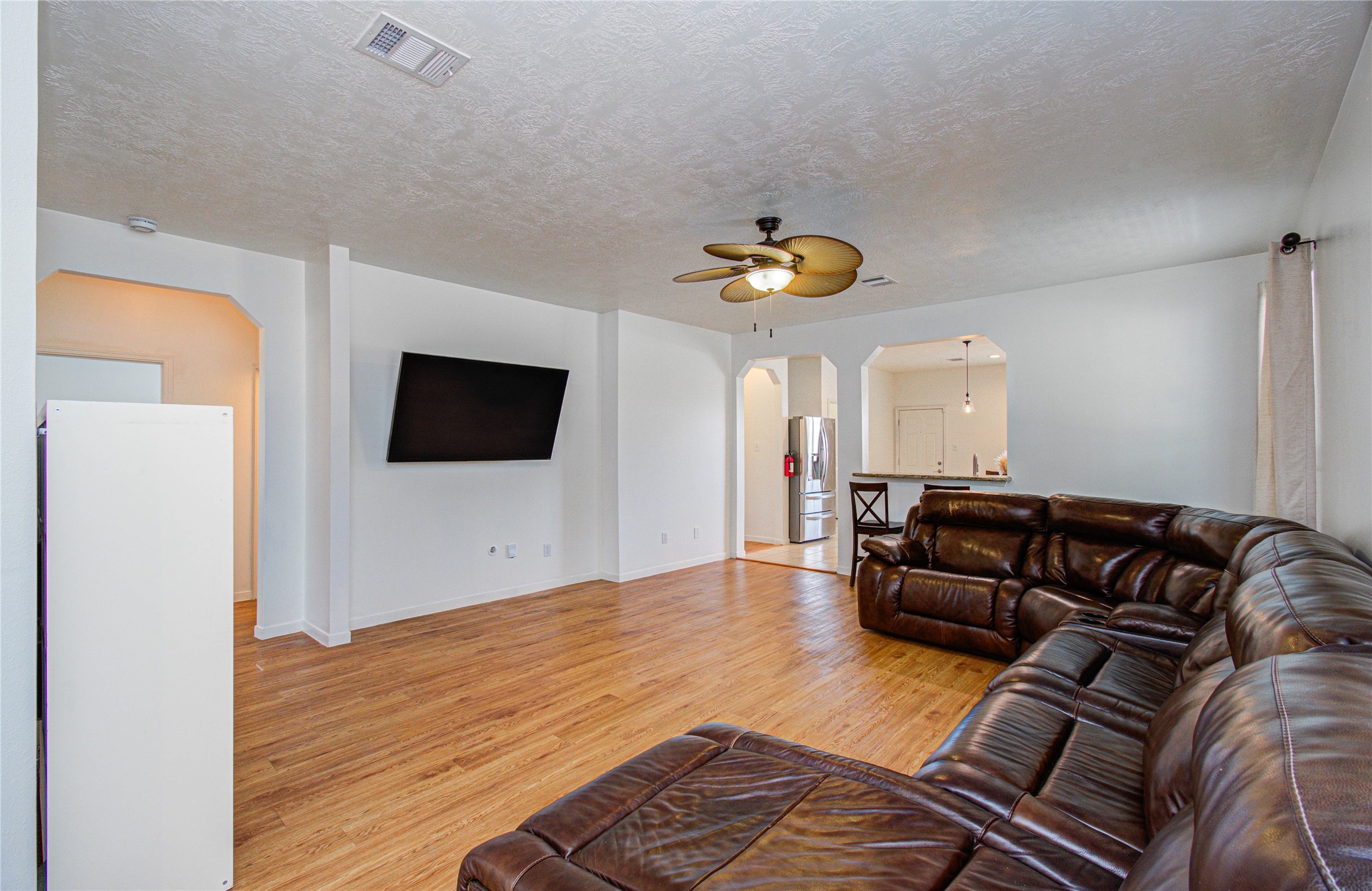 24135 Pinecreek Point Spring, TX 77373 - Photo 6 of 30 a living room with a couch and a flat screen tv