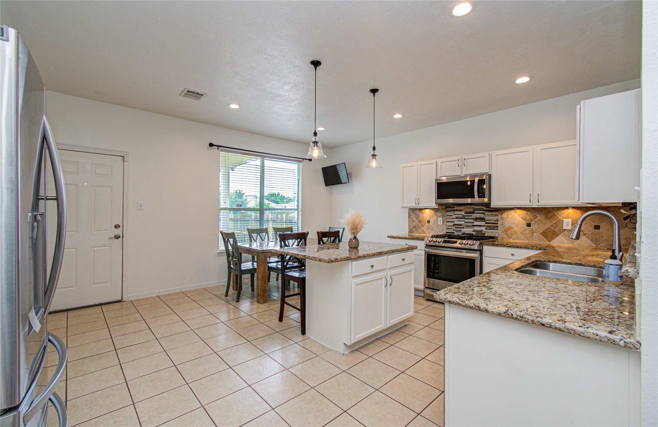 24135 Pinecreek Point Spring, TX 77373 - Photo 9 of 30 a kitchen with refrigerator and cabinets
