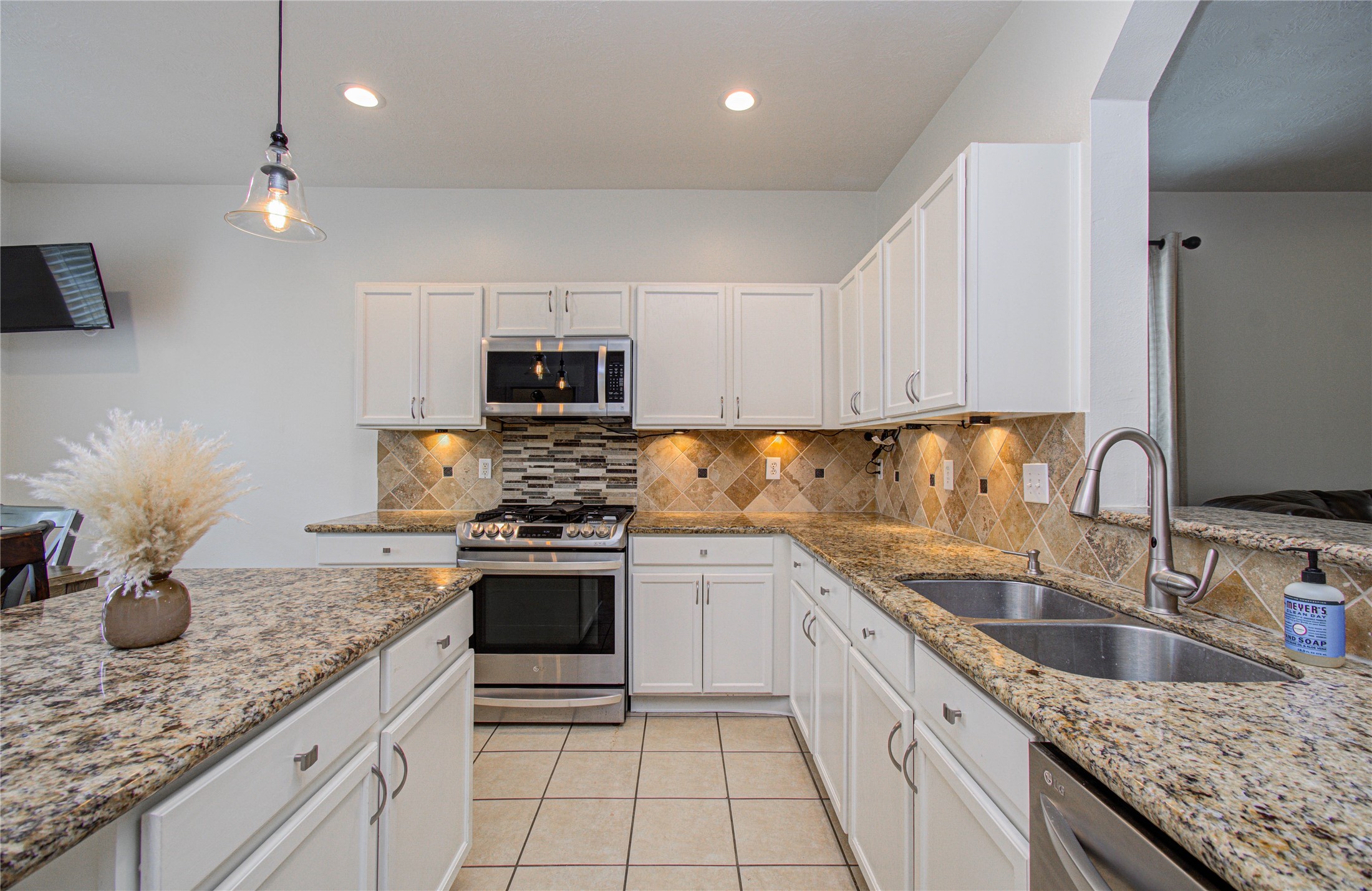 24135 Pinecreek Point Spring, TX 77373 - Photo 10 of 30 a kitchen with stainless steel appliances granite countertop a sink a stove and cabinets