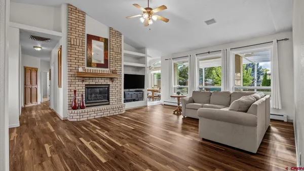 a living room with furniture flat screen tv and a fireplace