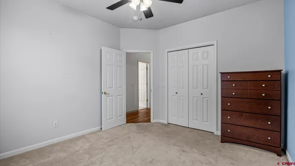 a view of an empty room with a ceiling fan