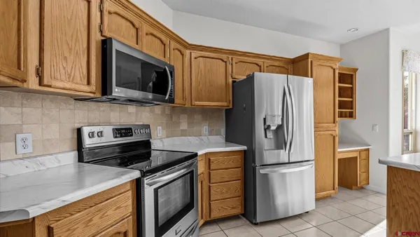 a kitchen with stainless steel appliances granite countertop a refrigerator stove and microwave