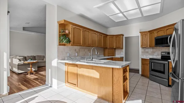 a kitchen with stainless steel appliances granite countertop a stove sink and cabinets