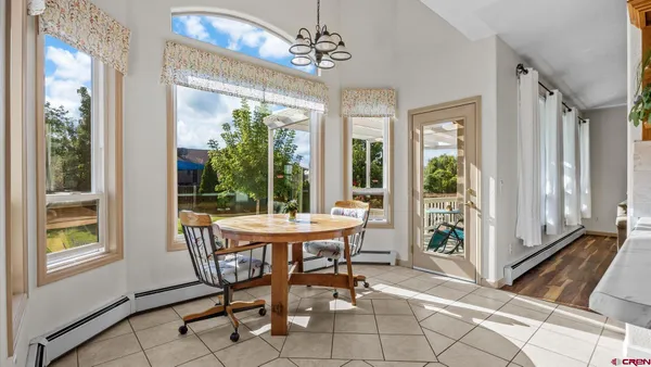 a dining room with furniture and window