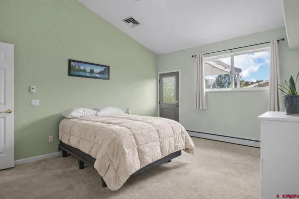 a bedroom with a bed and window