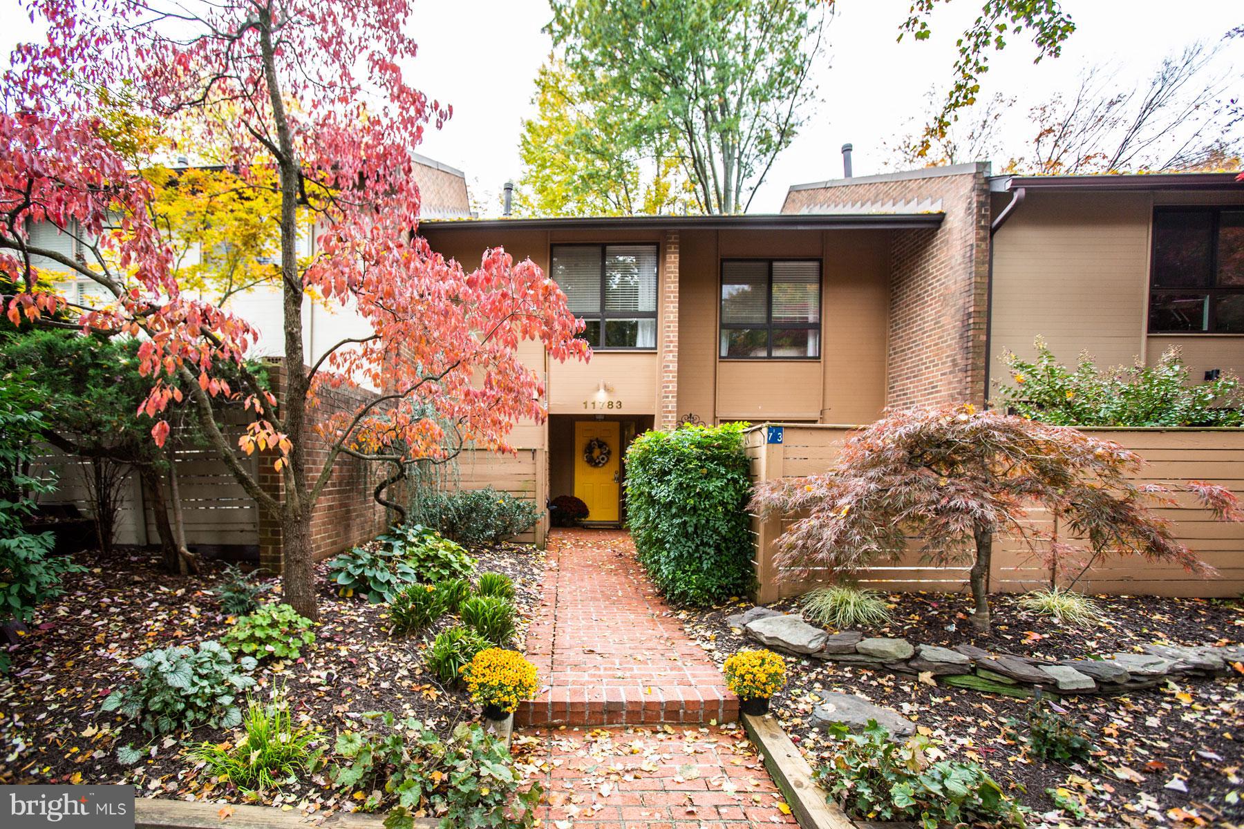 11783 Indian Ridge Road Reston, VA 20191 - Photo 1 of 25 a front view of a house with garden