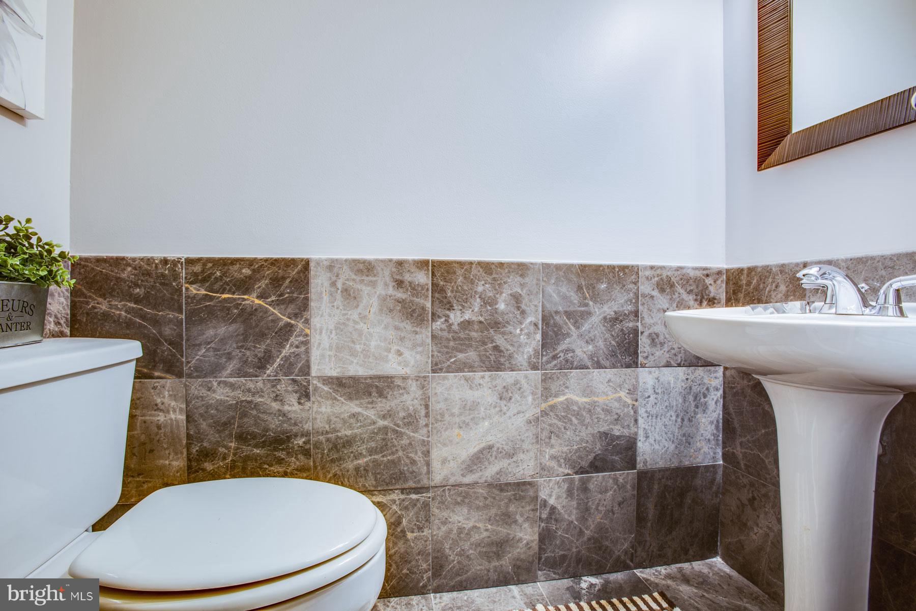 11783 Indian Ridge Road Reston, VA 20191 - Photo 11 of 25 a bathroom with a sink a toilet and a mirror