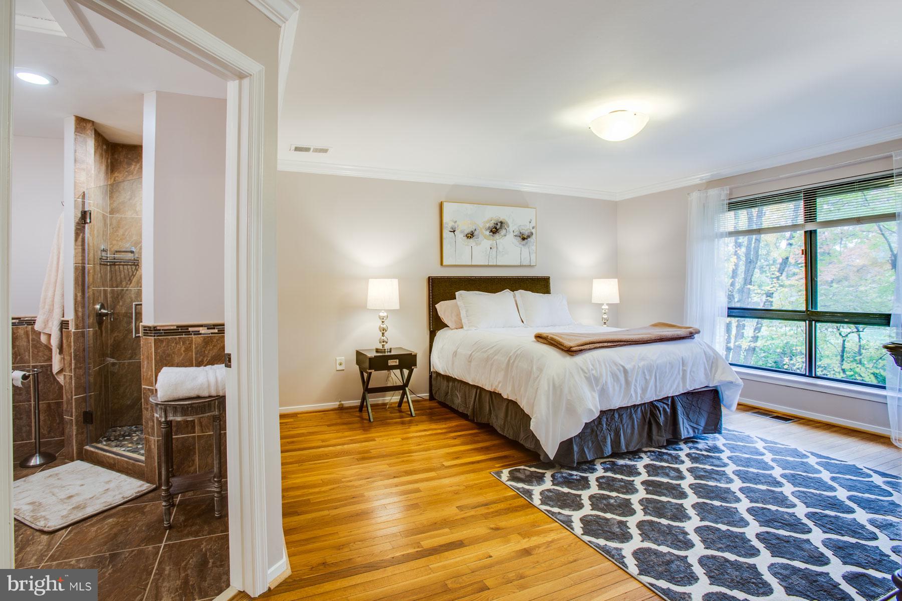 11783 Indian Ridge Road Reston, VA 20191 - Photo 12 of 25 a bedroom with a bed and wooden floor