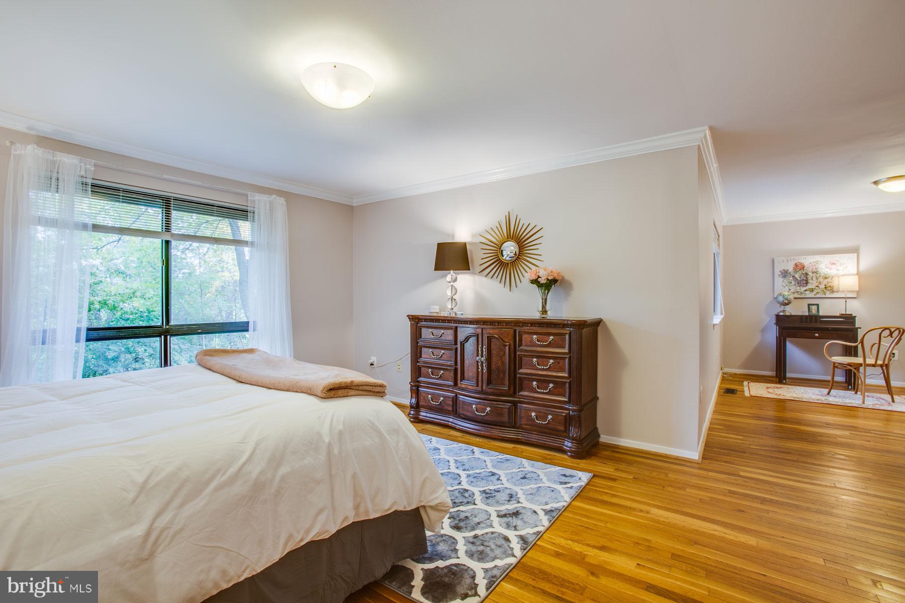 11783 Indian Ridge Road Reston, VA 20191 - Photo 13 of 25 a bedroom with a bed and wooden floor