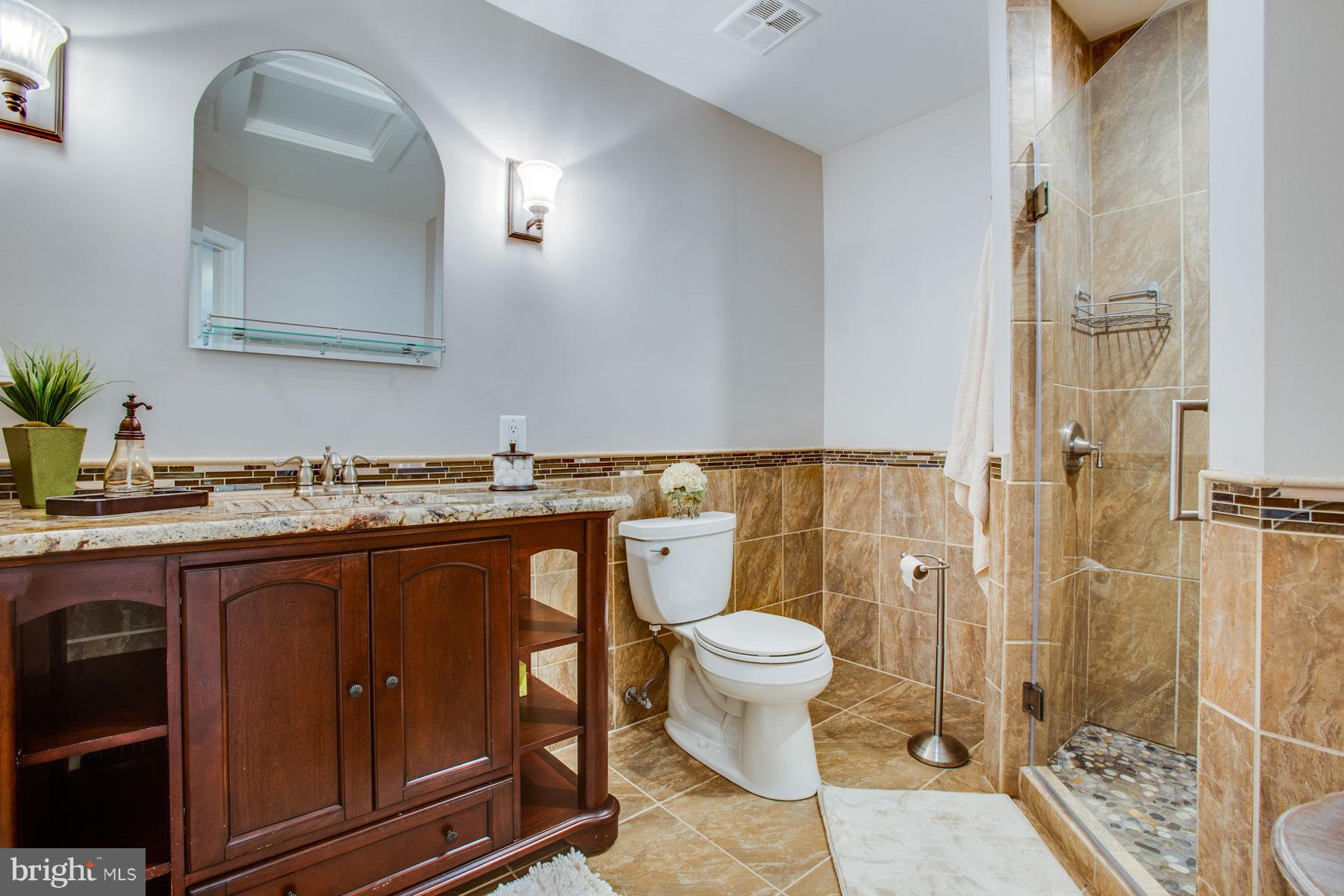 11783 Indian Ridge Road Reston, VA 20191 - Photo 15 of 25 a bathroom with a sink a toilet and shower