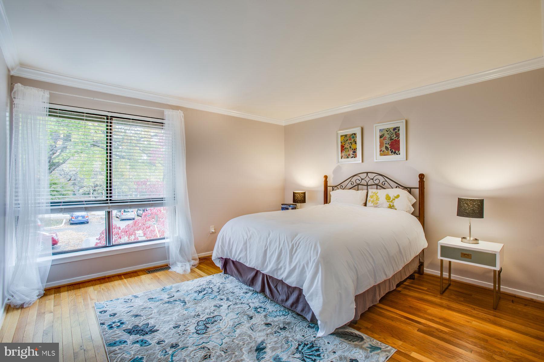 11783 Indian Ridge Road Reston, VA 20191 - Photo 16 of 25 a bedroom with a bed and wooden floor
