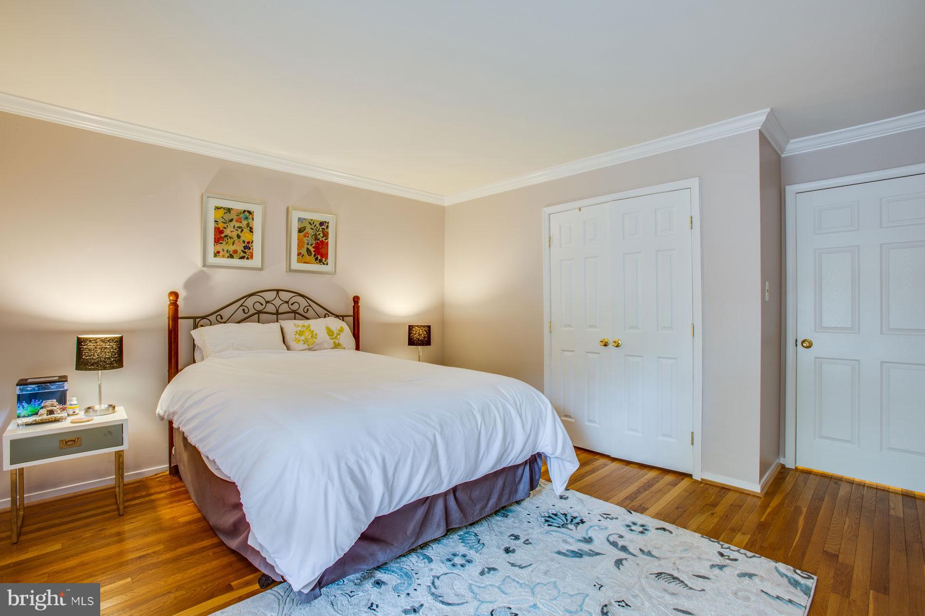 11783 Indian Ridge Road Reston, VA 20191 - Photo 17 of 25 a bedroom with a bed and a dresser