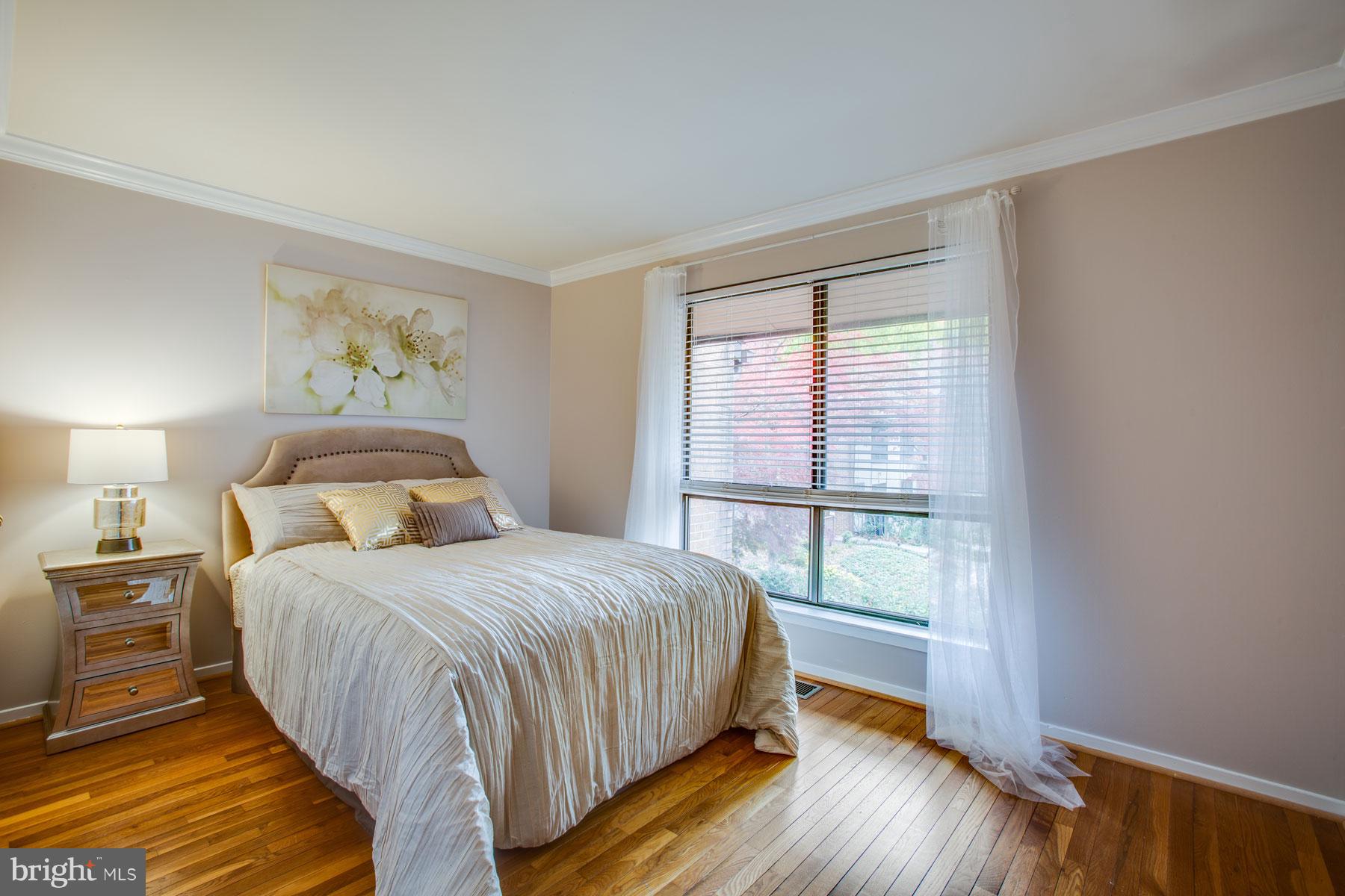 11783 Indian Ridge Road Reston, VA 20191 - Photo 18 of 25 a bedroom with a large bed and a window