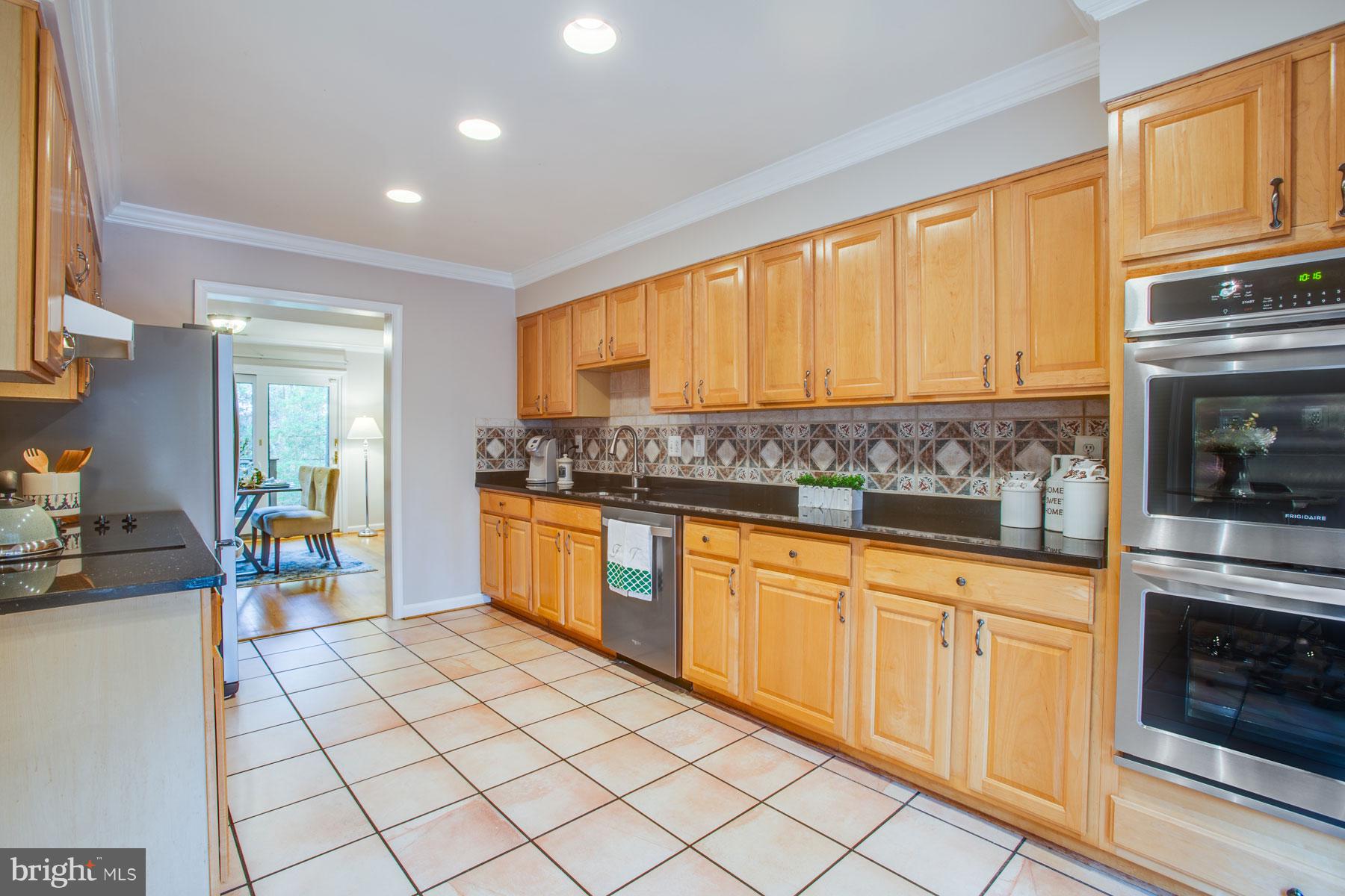 11783 Indian Ridge Road Reston, VA 20191 - Photo 4 of 25 a kitchen with stainless steel appliances granite countertop a stove a sink and a refrigerator