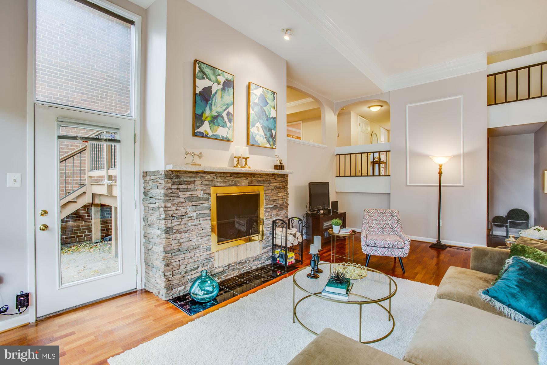 11783 Indian Ridge Road Reston, VA 20191 - Photo 6 of 25 a living room with fireplace furniture and a floor to ceiling window