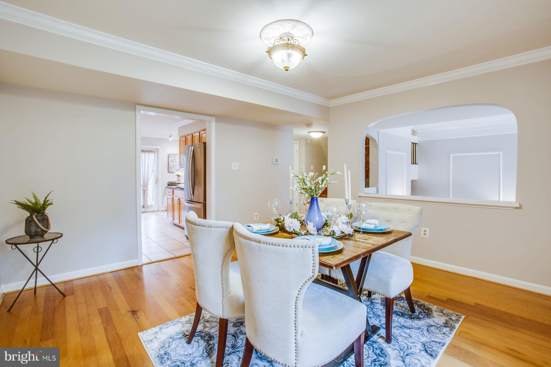 11783 Indian Ridge Road Reston, VA 20191 - Photo 9 of 25 a view of a dining room with furniture wooden floor and a chandelier