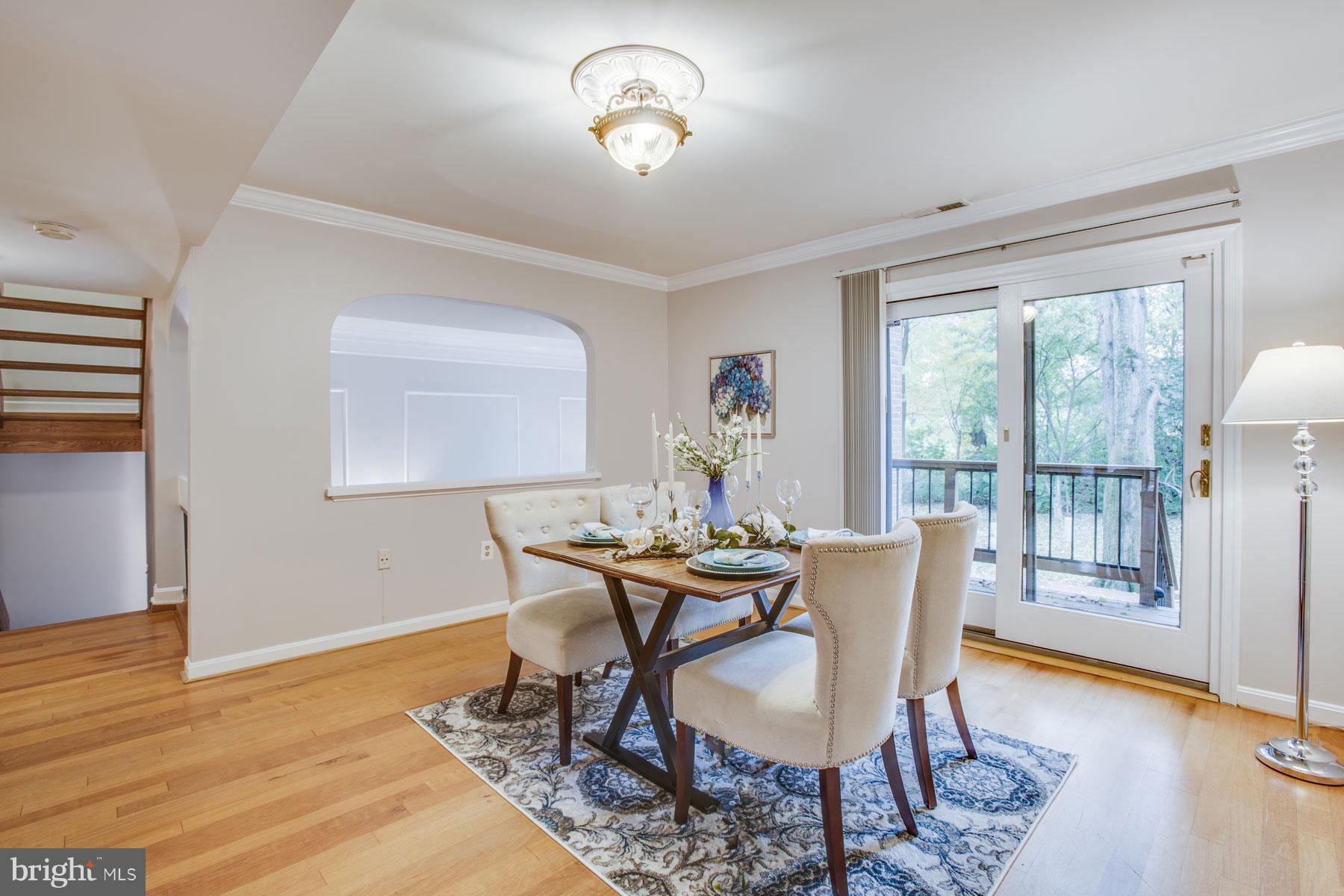 11783 Indian Ridge Road Reston, VA 20191 - Photo 10 of 25 a view of a dining room with furniture a chandelier and wooden floor