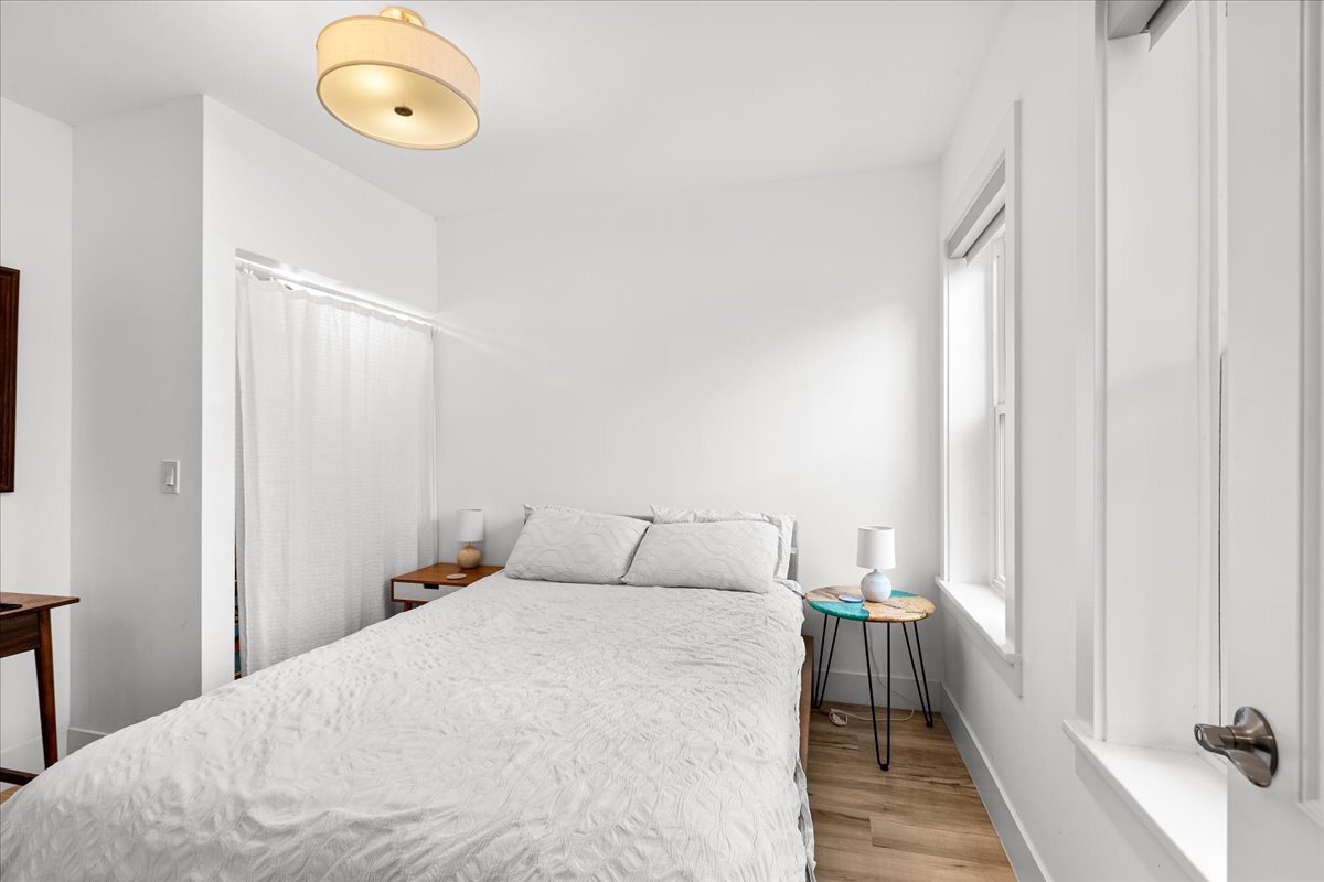 3144 North Spaulding Avenue, Unit 1 Chicago, IL 60618 - Photo 12 of 13 a bedroom with a bed and a chandelier