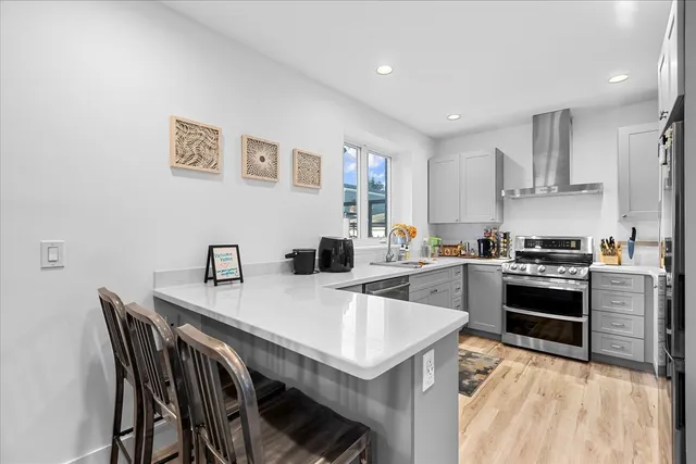 a kitchen with a refrigerator and a sink