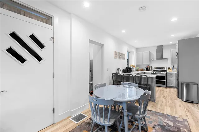 a living room with furniture and kitchen view