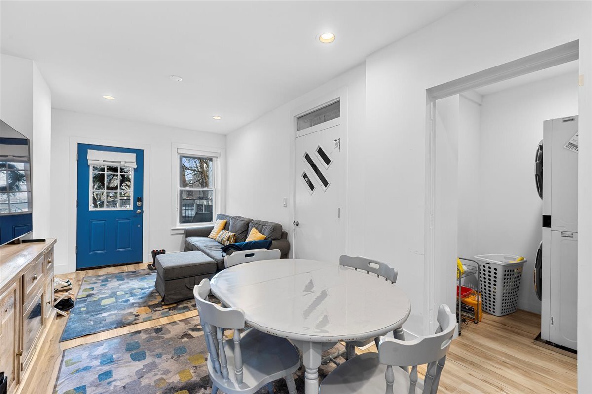 3144 North Spaulding Avenue, Unit 1 Chicago, IL 60618 - Photo 9 of 13 a living room with furniture a wooden floor and a bookshelf