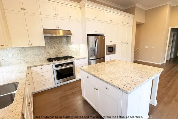 a stove top oven sitting inside of a kitchen