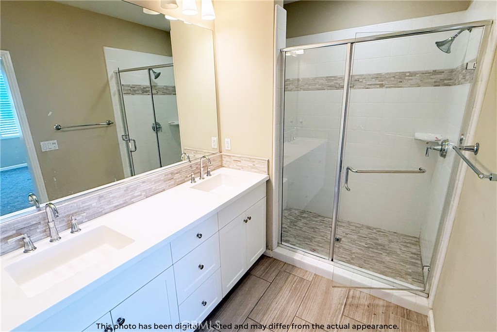 107 Mighty Oak Irvine, CA 92602 - Photo 20 of 22 a bathroom with a double vanity sink mirror and shower