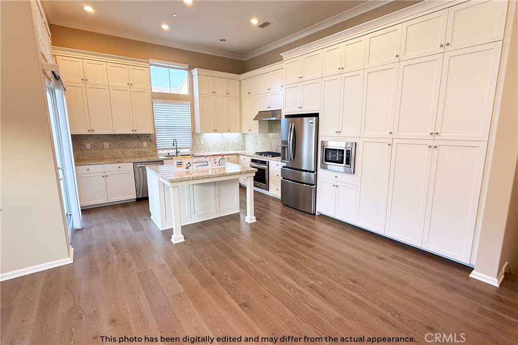 107 Mighty Oak Irvine, CA 92602 - Photo 9 of 22 a kitchen with stainless steel appliances a refrigerator sink and microwave