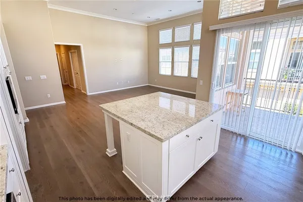 a kitchen with granite countertop white cabinets and stainless steel appliances