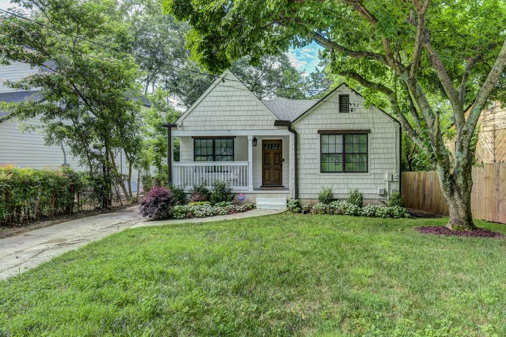 1833 Flat Shoals Road Southeast Atlanta, GA 30316 - Photo 1 of 1 a front view of house with yard and green space