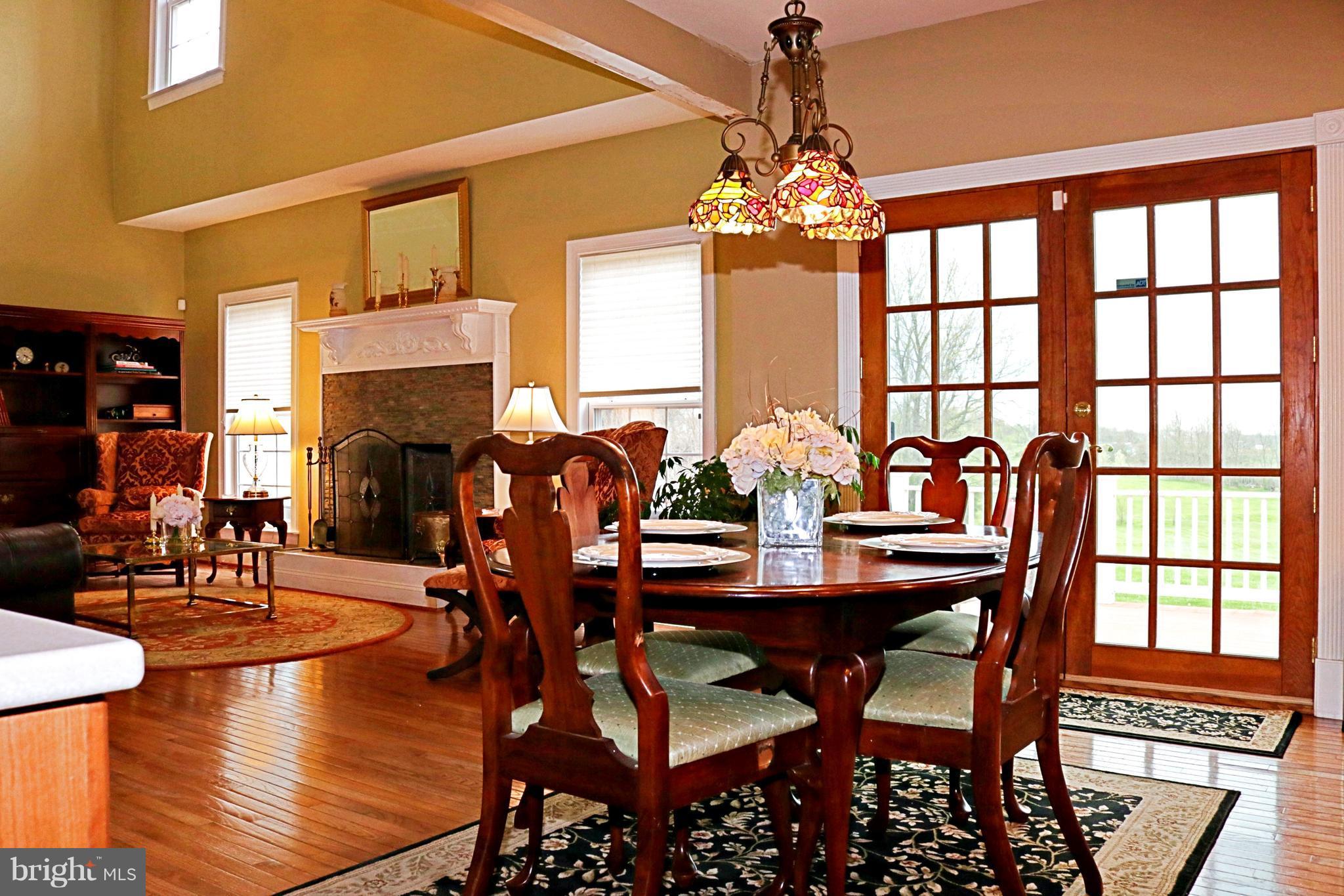 517 Rudder Road Shepherdstown, WV 25443 - Photo 11 of 25 a view of a dining room with furniture a chandelier and wooden floor
