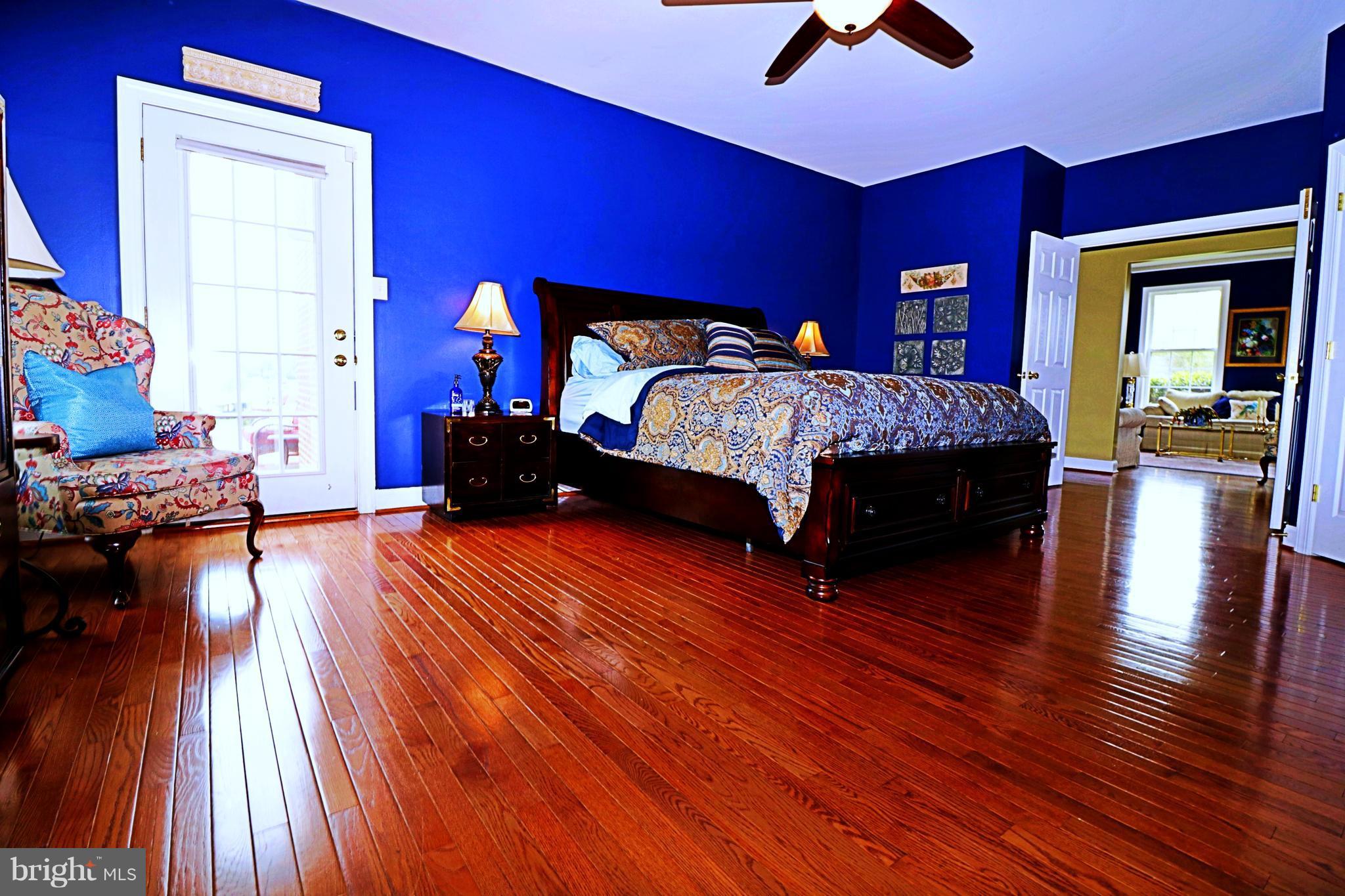 517 Rudder Road Shepherdstown, WV 25443 - Photo 17 of 25 a bedroom with a bed and wooden floor