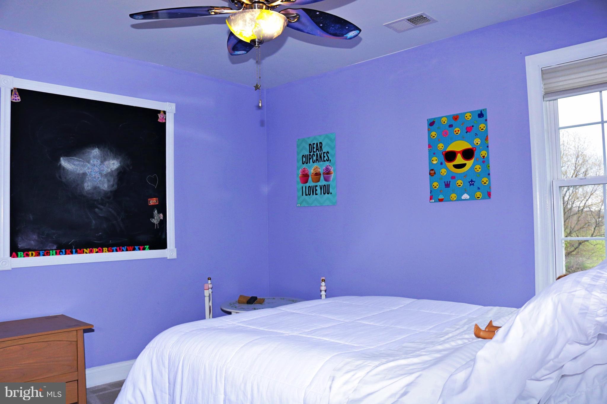 517 Rudder Road Shepherdstown, WV 25443 - Photo 20 of 25 a bedroom with a bed and a flat screen tv