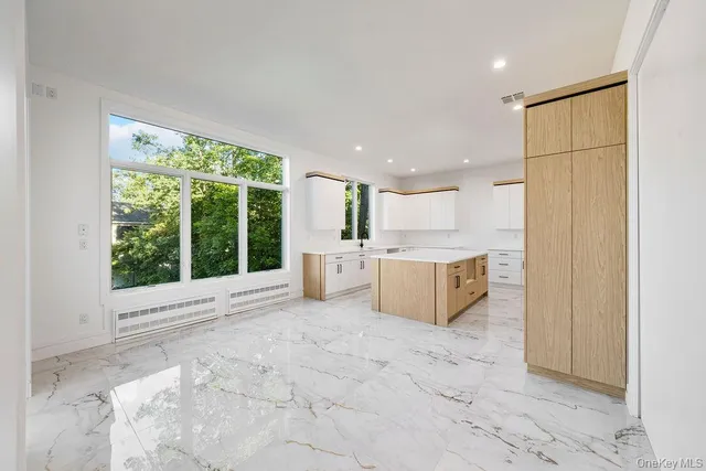 a view of a kitchen with a sink and cabinets