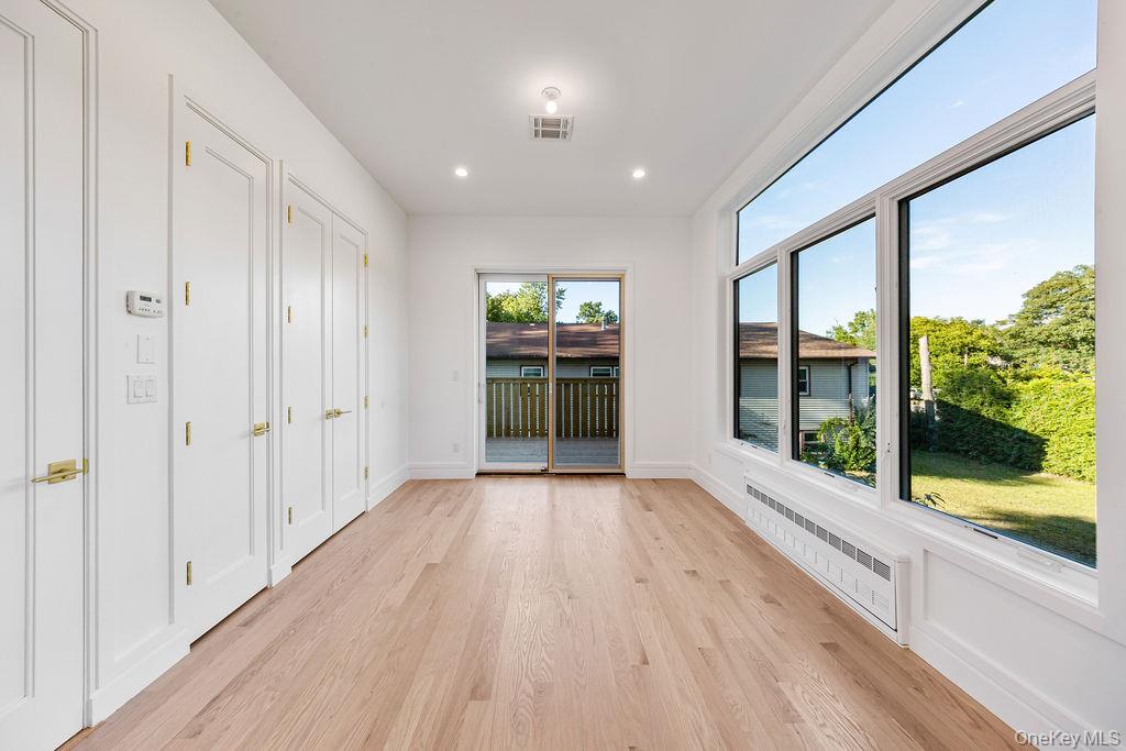 40 Singer Avenue, Unit 201 Spring Valley, NY 10977 - Photo 15 of 50 a view of an empty room with wooden floor and a window