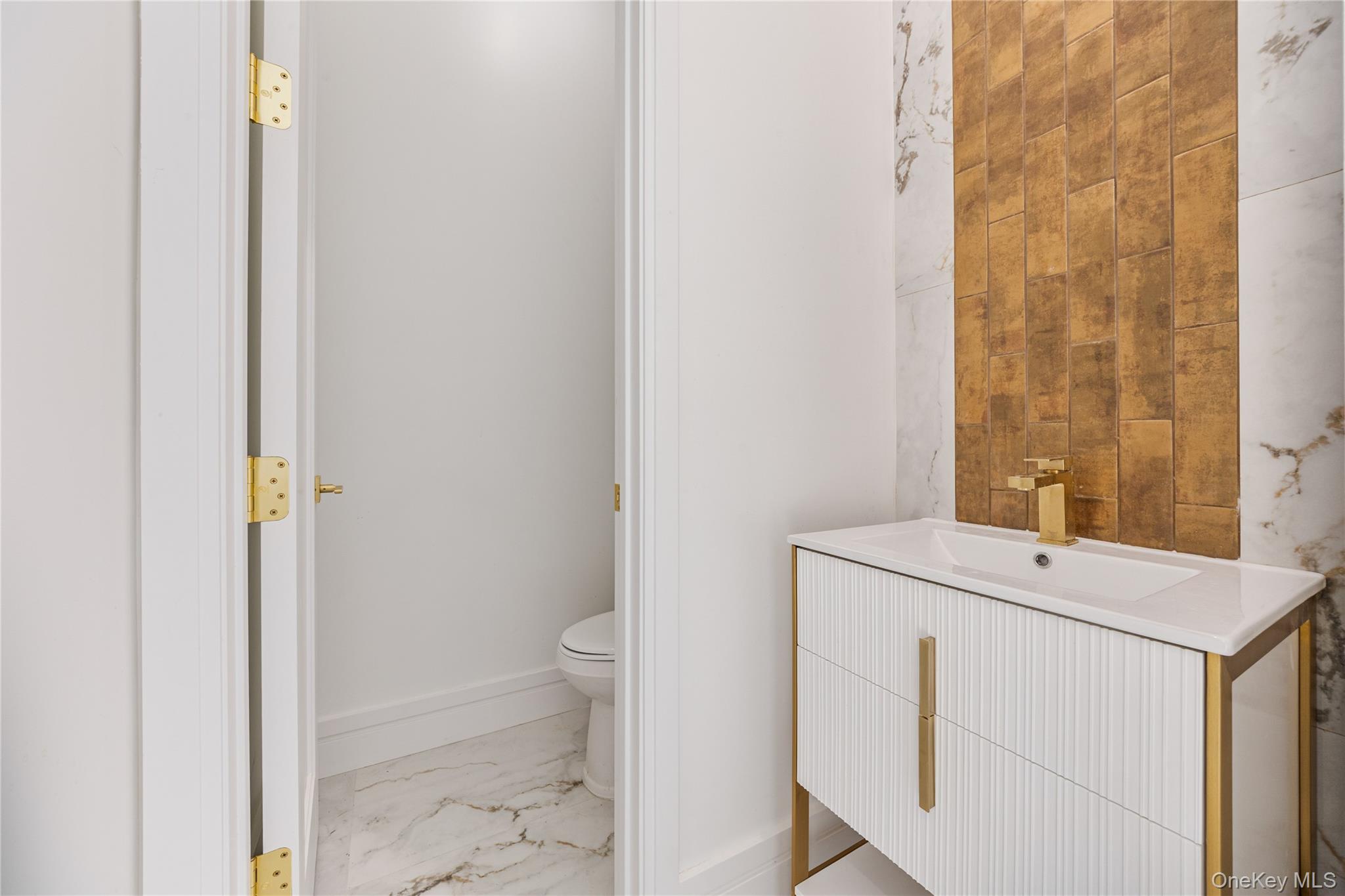 40 Singer Avenue, Unit 201 Spring Valley, NY 10977 - Photo 17 of 50 a bathroom with a sink a toilet and a mirror